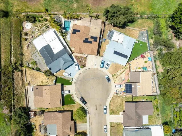 an aerial view of residential houses with outdoor space