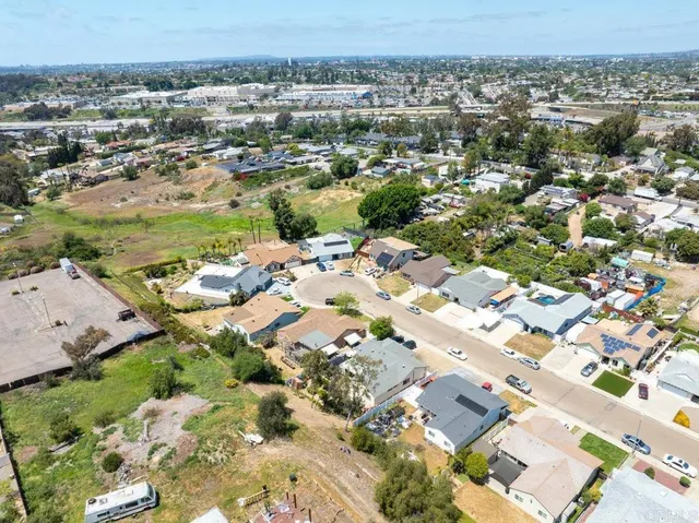 an aerial view of a residential houses with outdoor space