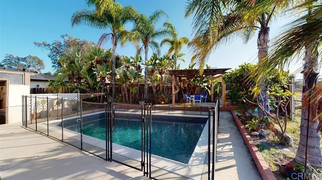 a view of swimming pool with a table and chairs