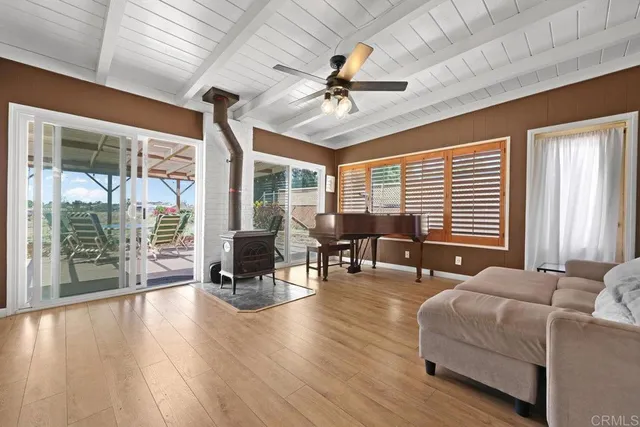 a living room with furniture and large windows
