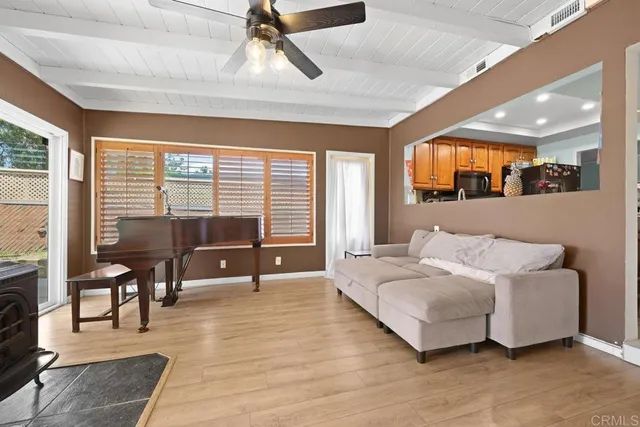 a bedroom with furniture and a large window