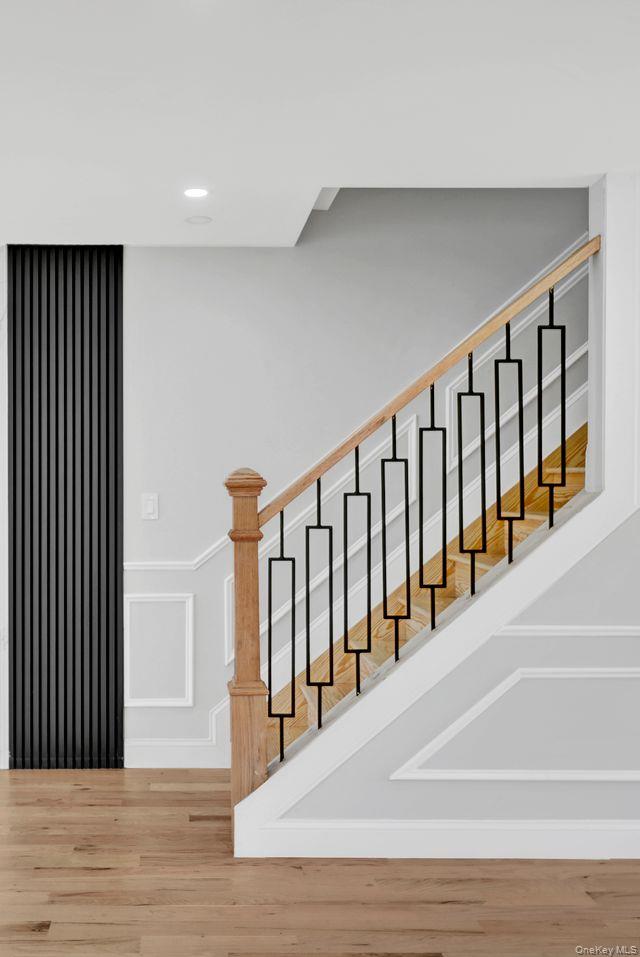 217-14 133rd Road Queens, NY 11413 - Photo 15 of 32 a view of staircase with railing and white walls