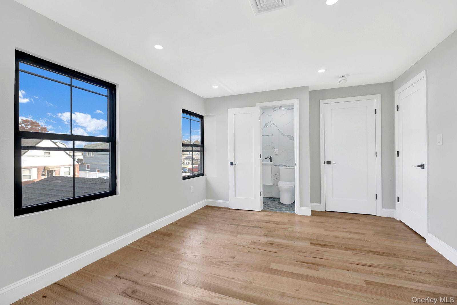 217-14 133rd Road Queens, NY 11413 - Photo 18 of 32 a view of empty room with wooden floor and fan