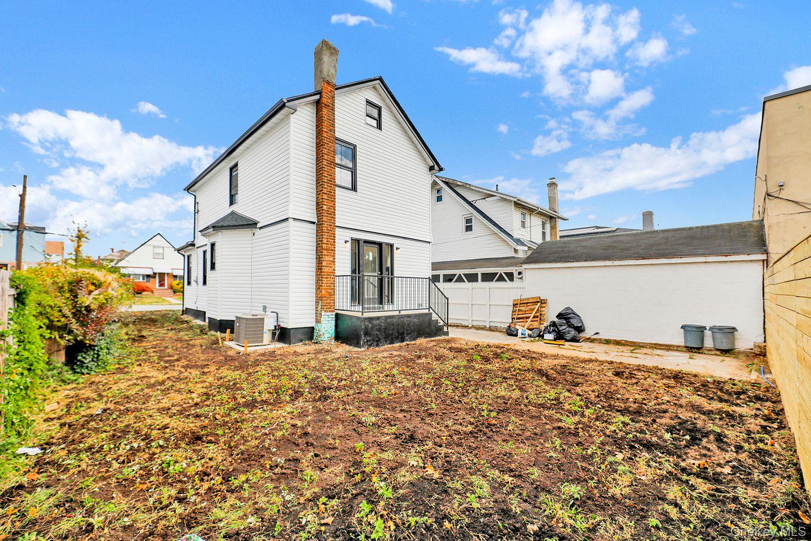 217-14 133rd Road Queens, NY 11413 - Photo 29 of 32 a view of a house with snow on the side of the road