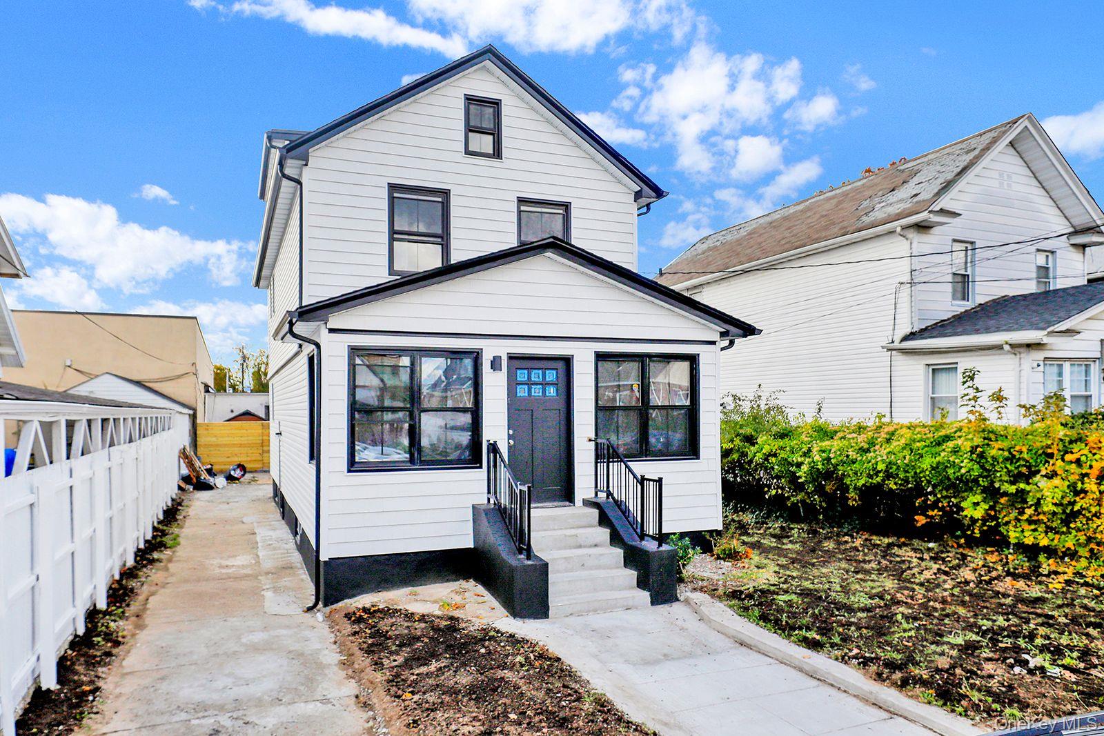 217-14 133rd Road Queens, NY 11413 - Photo 31 of 32 a front view of a house with a yard