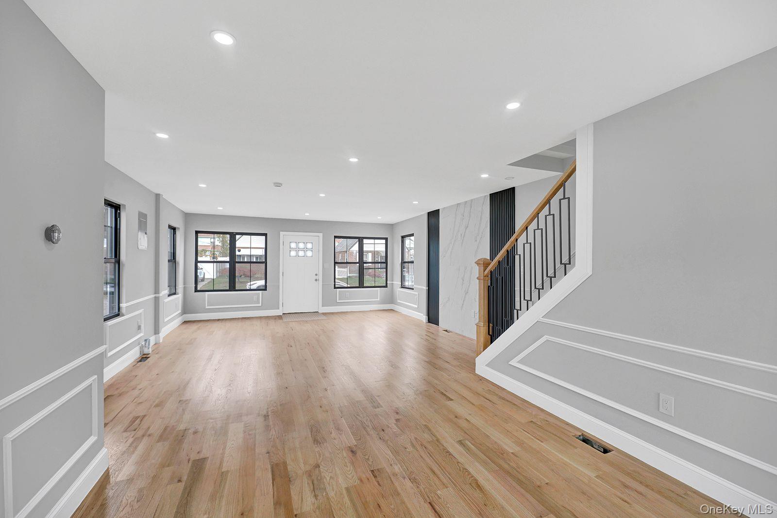 217-14 133rd Road Queens, NY 11413 - Photo 8 of 32 a view of an empty room with wooden floor and a window