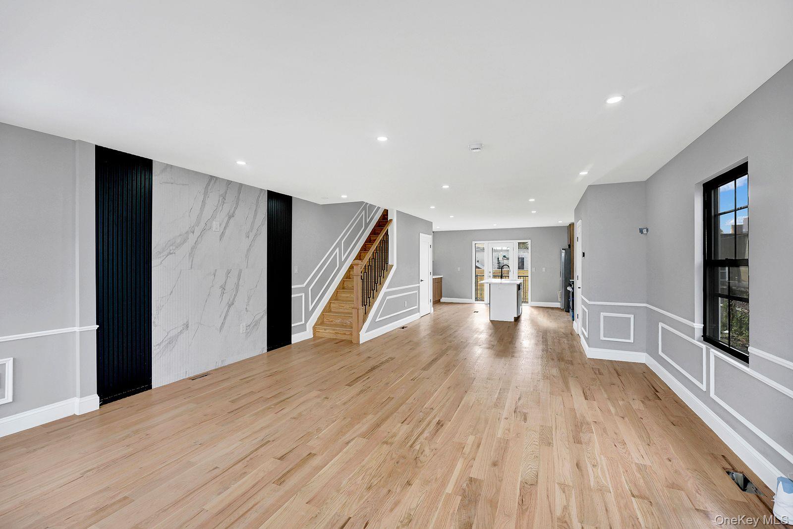 217-14 133rd Road Queens, NY 11413 - Photo 10 of 32 a view of a big room with wooden floor and windows