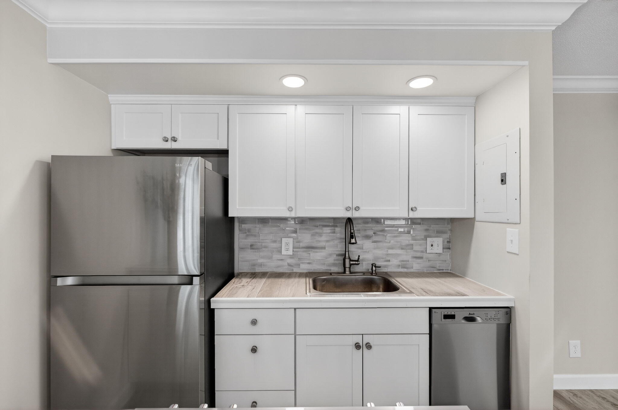 3600 North Ocean Drive, Unit 223 Singer Island, FL 33404 - Photo 13 of 47 a kitchen with a sink a refrigerator and cabinets