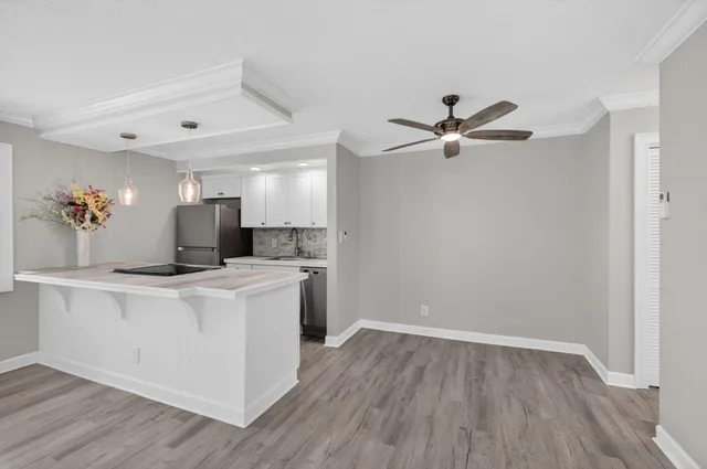 an empty room with a stove and wooden floor