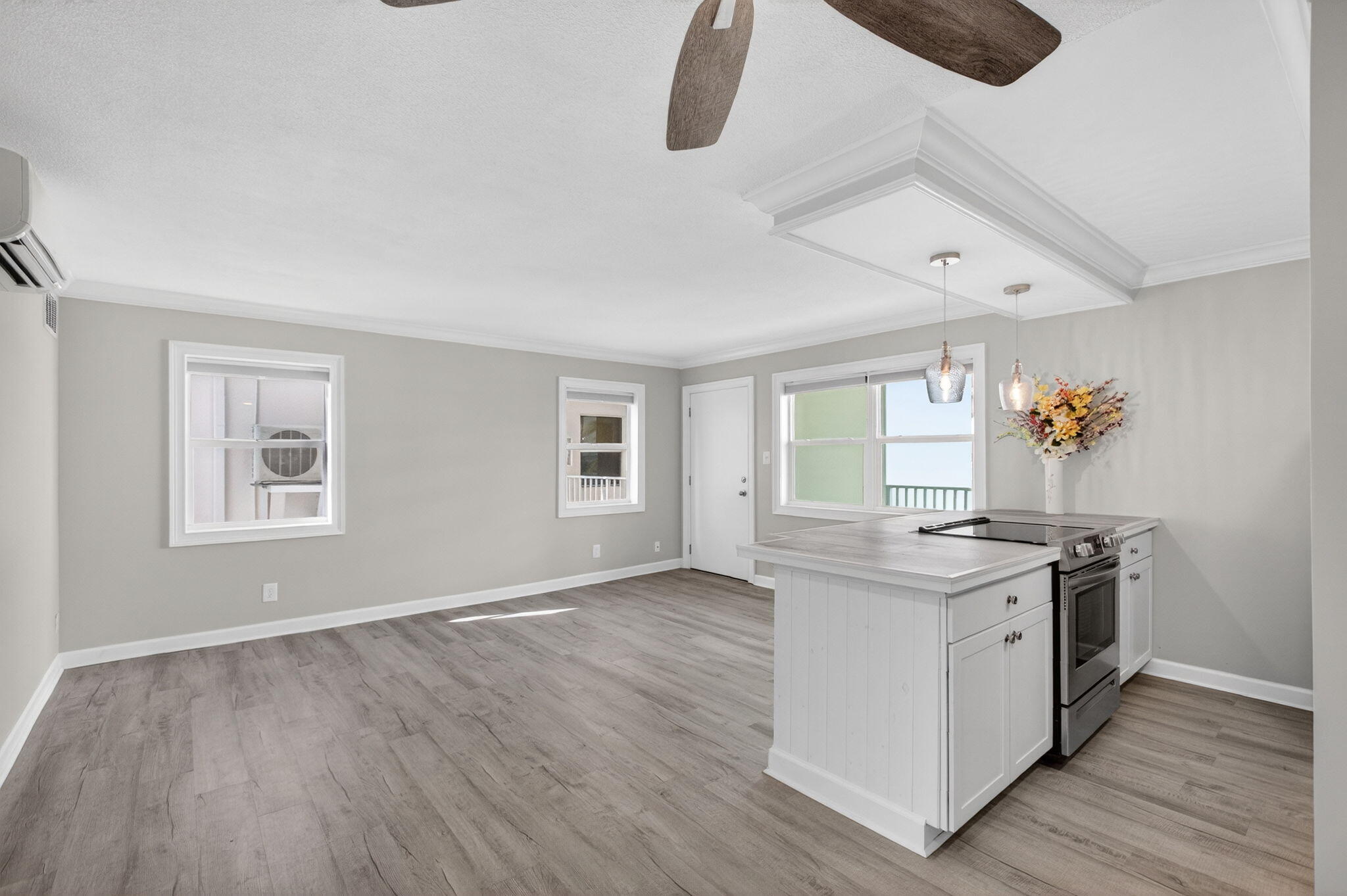 3600 North Ocean Drive, Unit 223 Singer Island, FL 33404 - Photo 15 of 47 an empty room with a stove and wooden floor