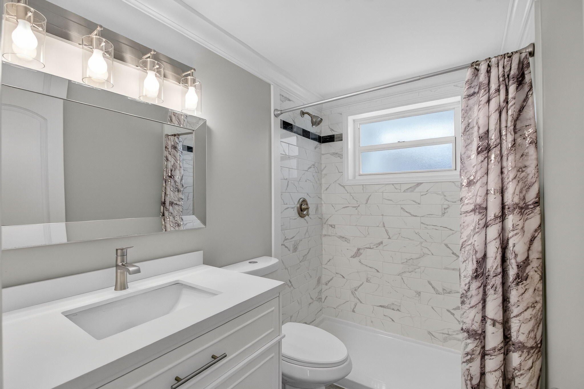 3600 North Ocean Drive, Unit 223 Singer Island, FL 33404 - Photo 17 of 47 a bathroom with a sink a toilet a mirror and shower