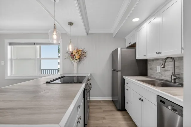 a kitchen with a sink stove and refrigerator
