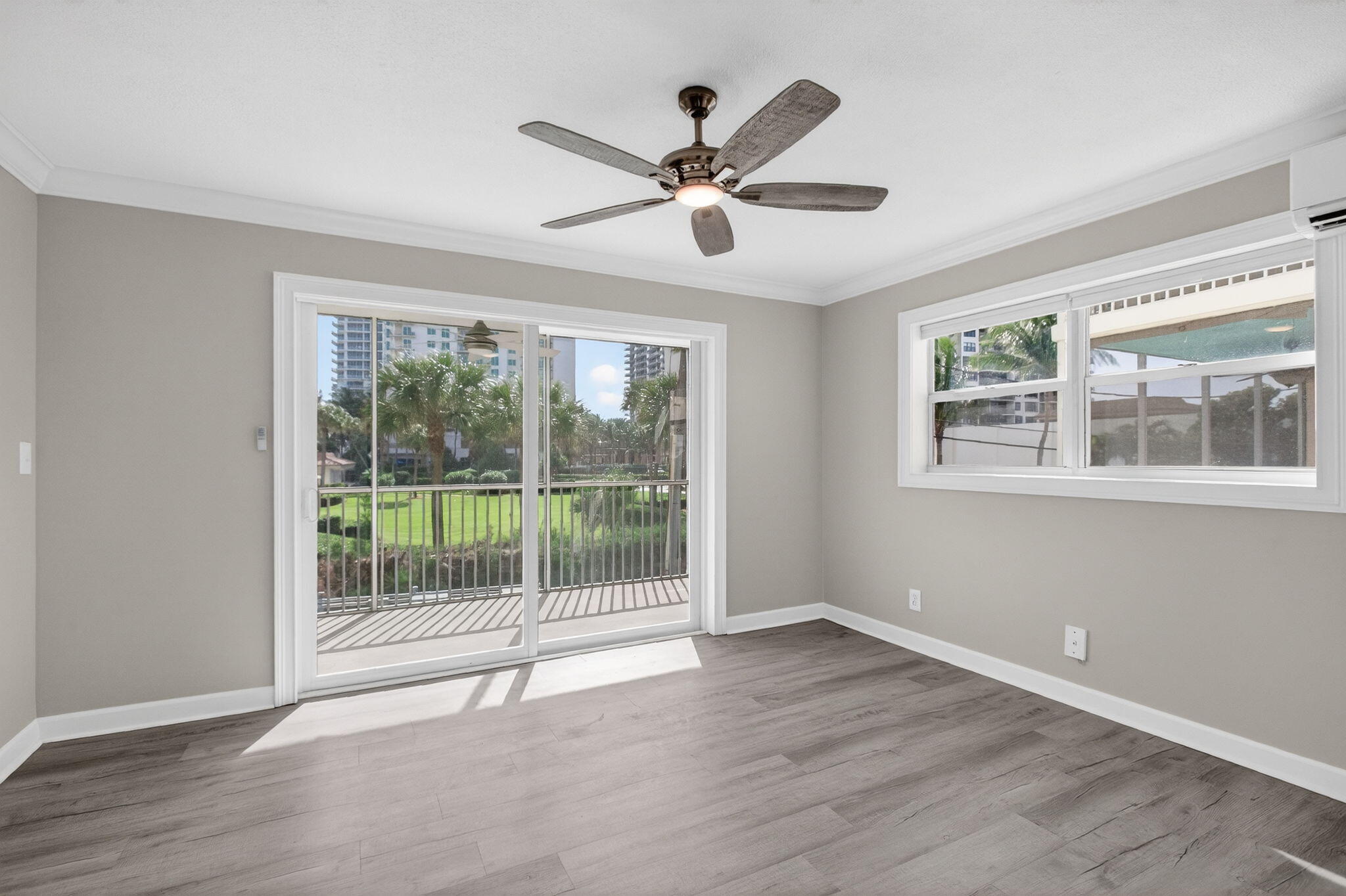 3600 North Ocean Drive, Unit 223 Singer Island, FL 33404 - Photo 22 of 47 a view of an empty room with wooden floor and a window