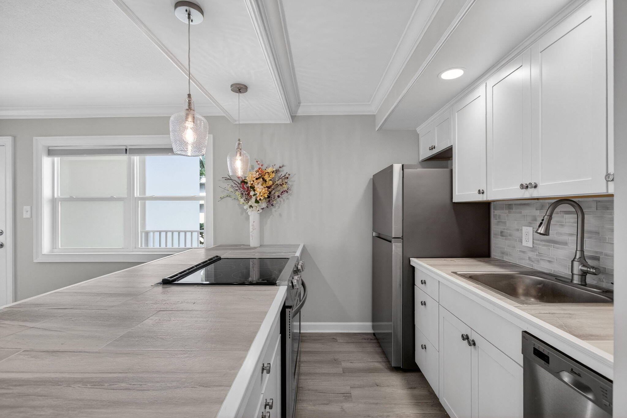 3600 North Ocean Drive, Unit 223 Singer Island, FL 33404 - Photo 3 of 47 a kitchen with a refrigerator sink and cabinets