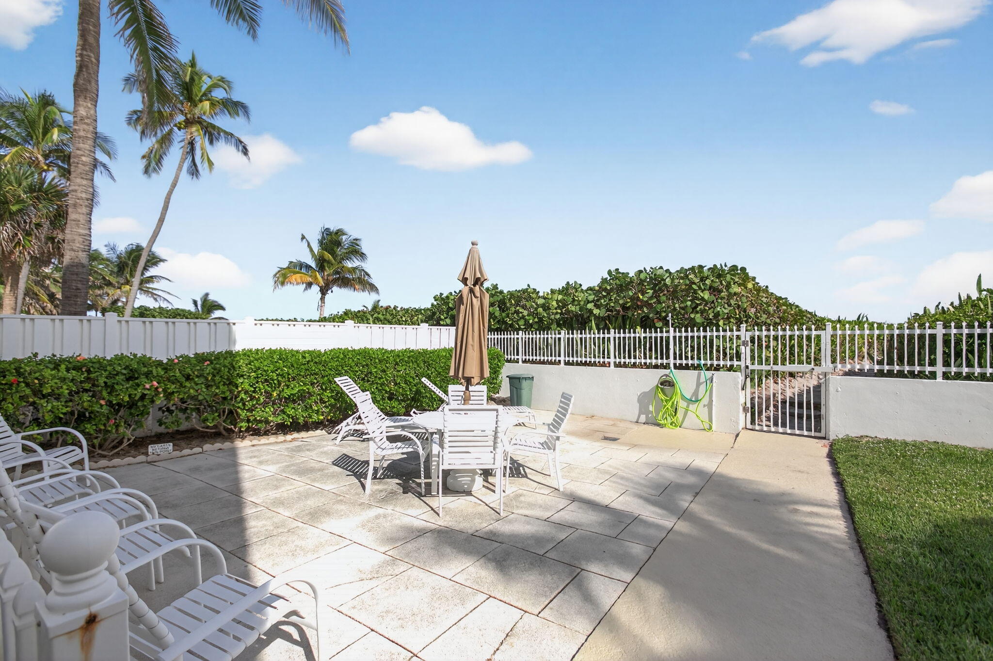 3600 North Ocean Drive, Unit 223 Singer Island, FL 33404 - Photo 36 of 47 a view of a chair and tables in the patio