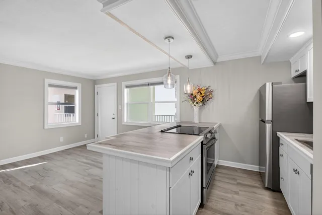 a kitchen with a stove a refrigerator and a sink