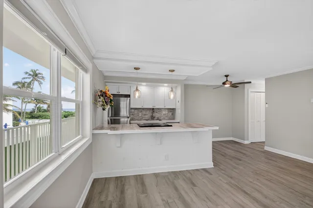 a view of a kitchen with a sink and wooden floor