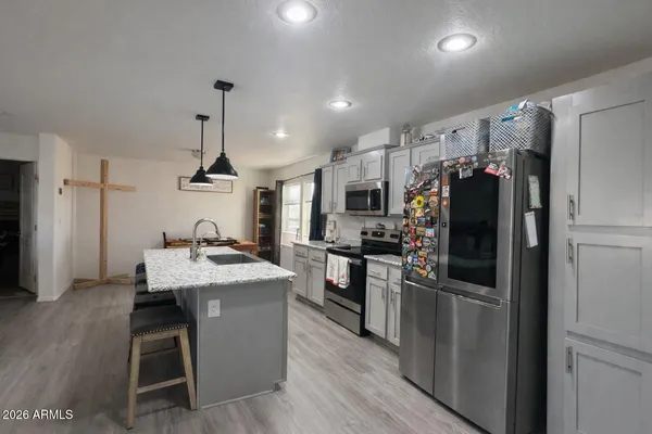 a kitchen with a refrigerator a sink and a stove