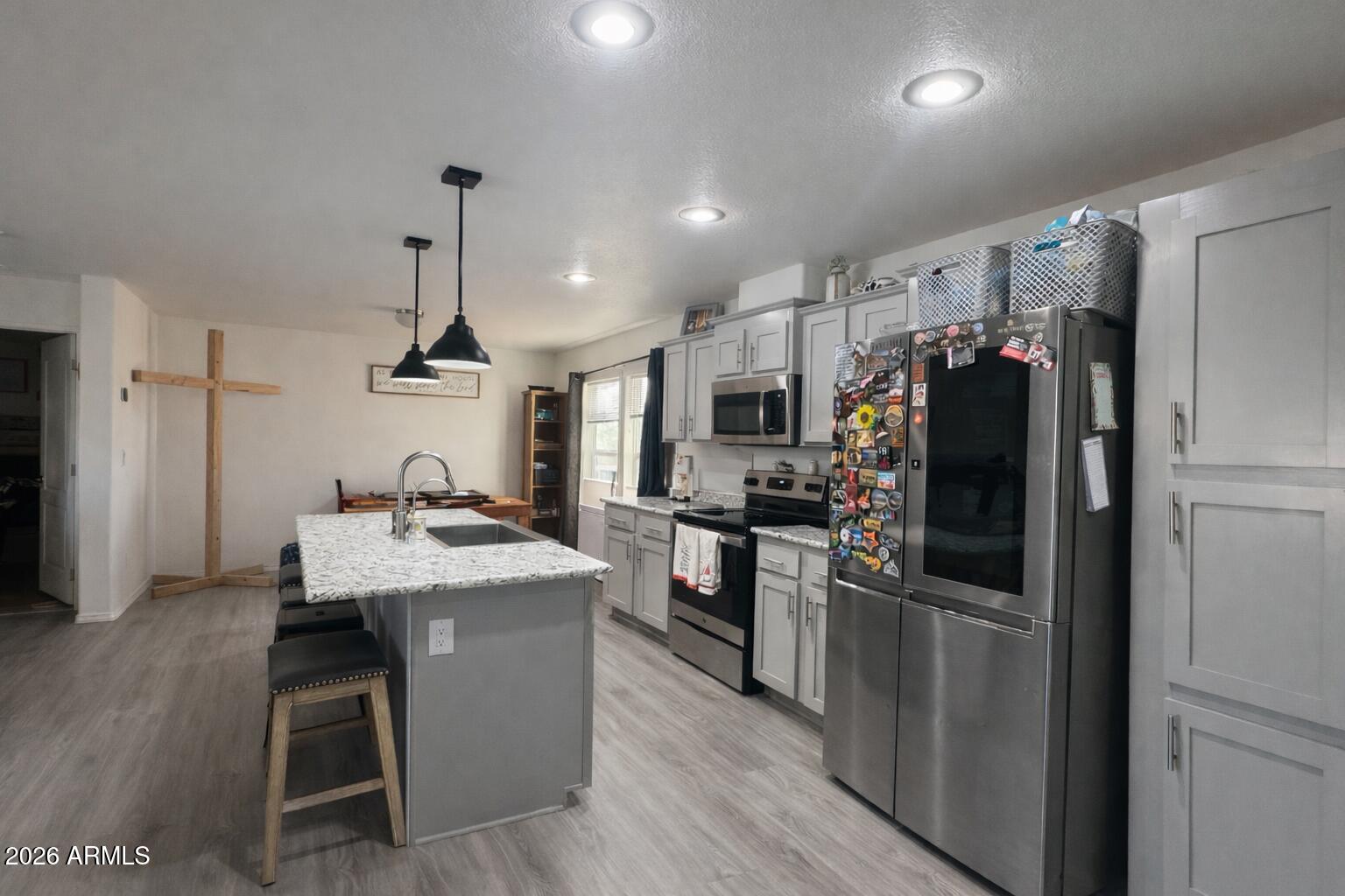 a kitchen with a refrigerator a sink and a stove