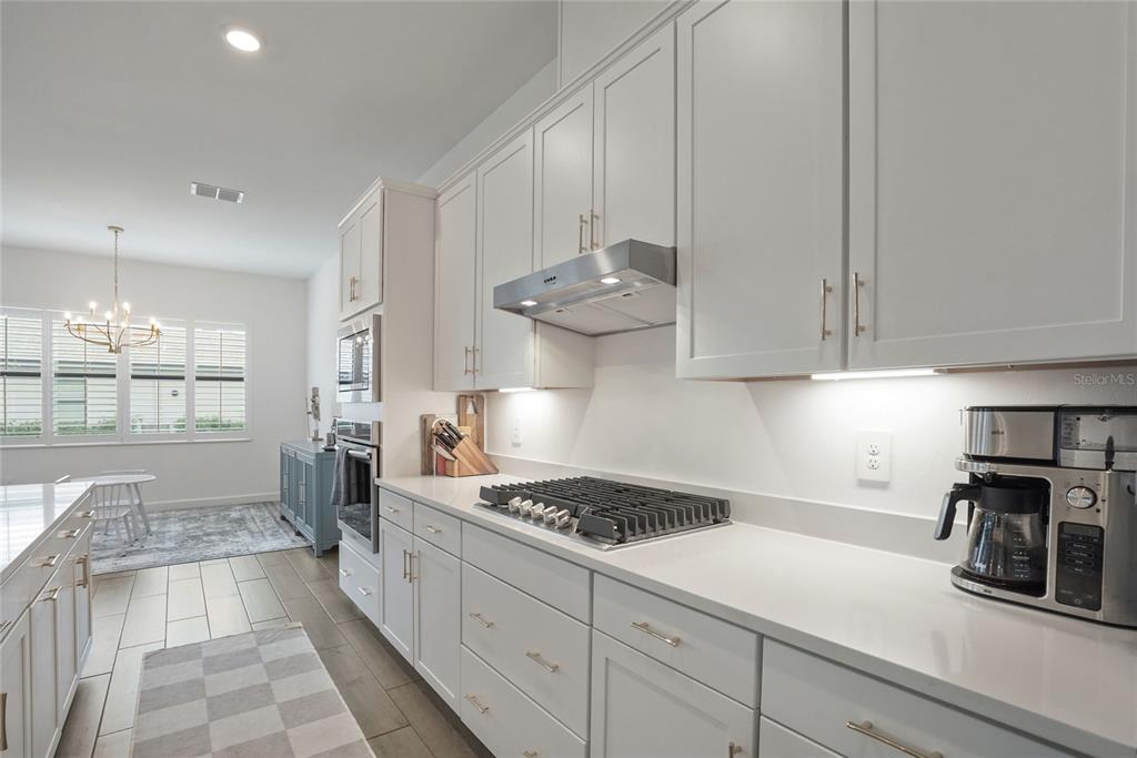 15906 Tradewind Terrace Lakewood Ranch, FL 34211 - Photo 11 of 67 a kitchen with stainless steel appliances granite countertop a sink stove and cabinets