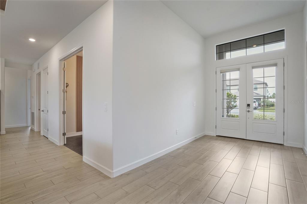 15906 Tradewind Terrace Lakewood Ranch, FL 34211 - Photo 16 of 67 a view of an empty room with wooden floor and a window