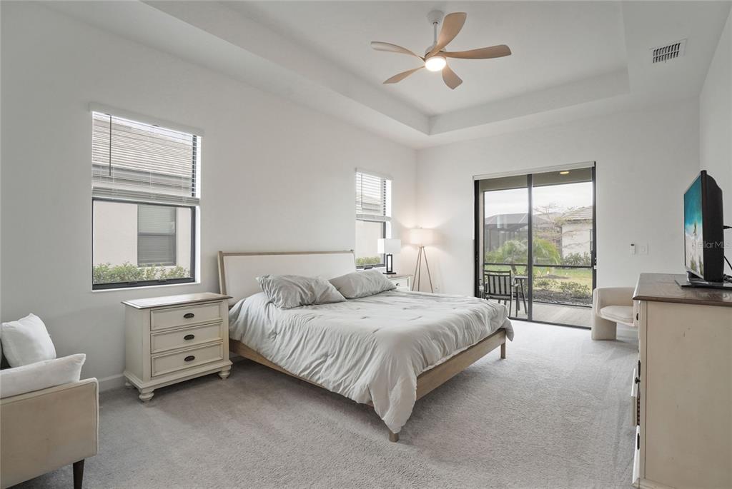 15906 Tradewind Terrace Lakewood Ranch, FL 34211 - Photo 17 of 67 a bedroom with a bed and a flat screen tv