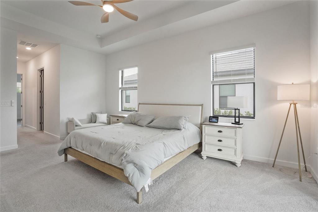 15906 Tradewind Terrace Lakewood Ranch, FL 34211 - Photo 18 of 67 a bedroom with a bed and a chandelier