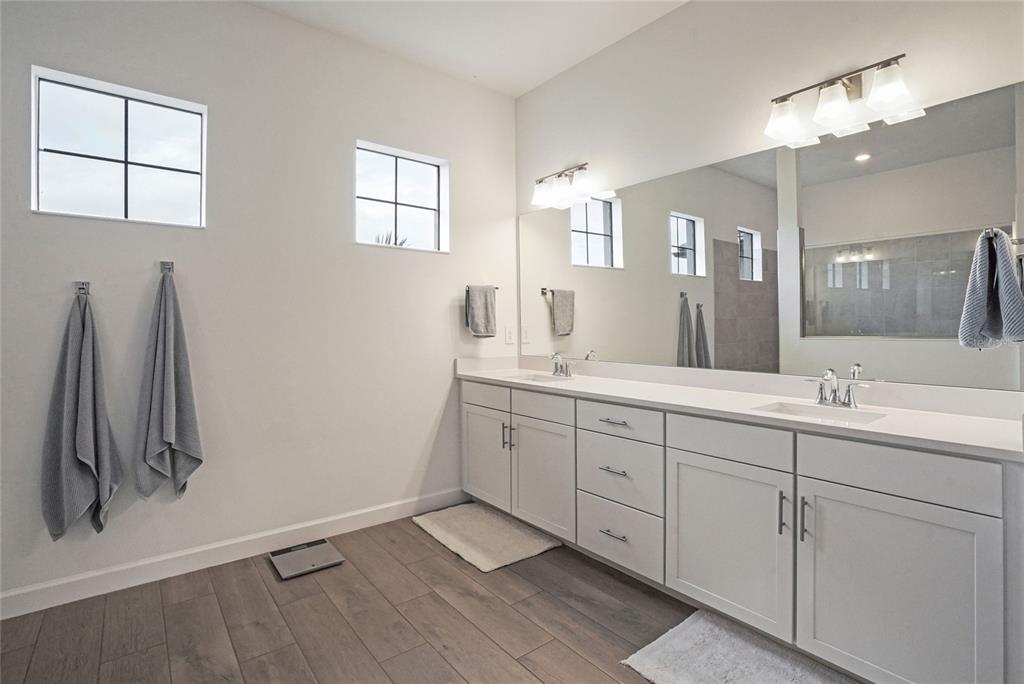 15906 Tradewind Terrace Lakewood Ranch, FL 34211 - Photo 19 of 67 a spacious bathroom with a double vanity sink a mirror and a shower