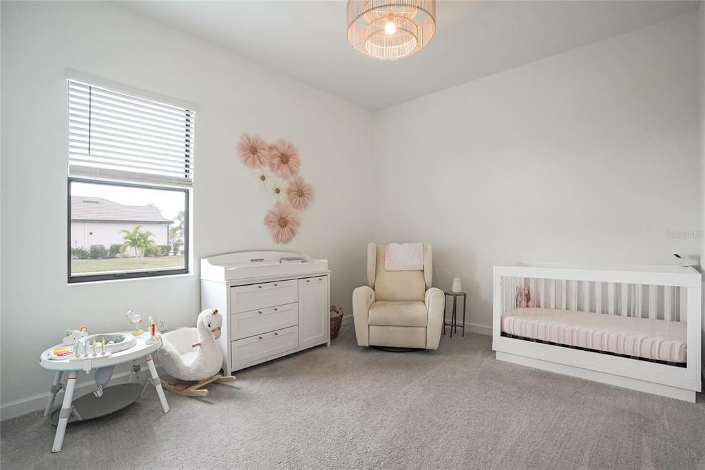 15906 Tradewind Terrace Lakewood Ranch, FL 34211 - Photo 22 of 67 a room with a baby bed furniture and a window