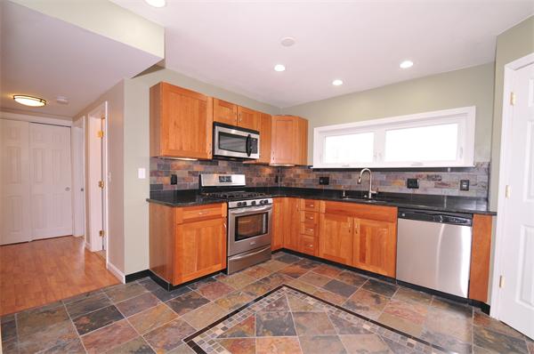 28 Hardwick Road Natick, MA 01760 - Photo 13 of 30 a kitchen with stainless steel appliances granite countertop a stove a sink and a refrigerator