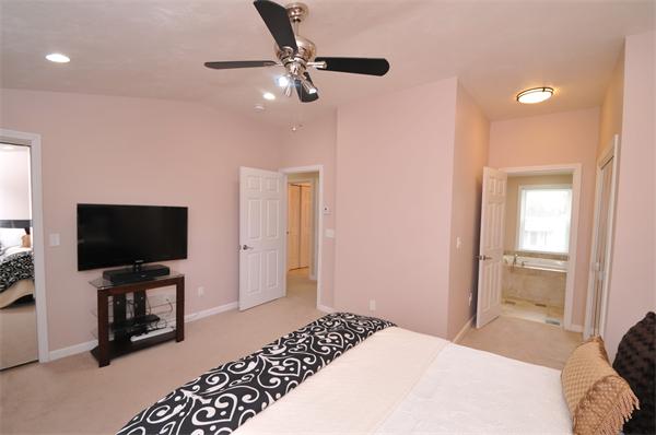 28 Hardwick Road Natick, MA 01760 - Photo 20 of 30 a bedroom with a bed and a flat screen tv