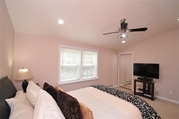 28 Hardwick Road Natick, MA 01760 - Photo 22 of 30 a bedroom with a bed and a flat screen tv