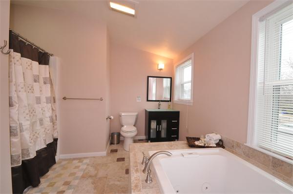 28 Hardwick Road Natick, MA 01760 - Photo 23 of 30 a bedroom with a bed and a fireplace