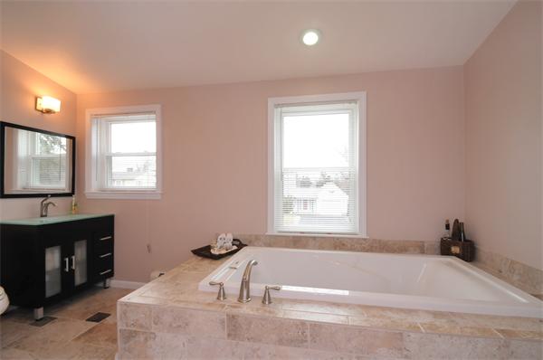 28 Hardwick Road Natick, MA 01760 - Photo 24 of 30 a bathroom with a bathtub and a sink