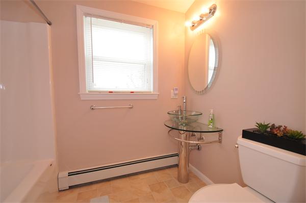 28 Hardwick Road Natick, MA 01760 - Photo 25 of 30 a bathroom with a toilet a sink and a mirror