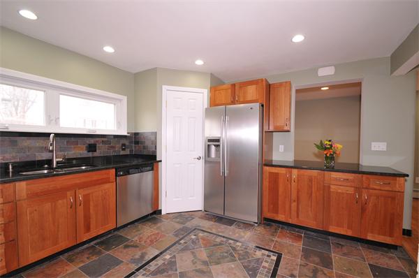 28 Hardwick Road Natick, MA 01760 - Photo 9 of 30 a large kitchen with stainless steel appliances granite countertop a sink and a refrigerator