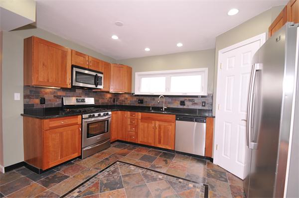 28 Hardwick Road Natick, MA 01760 - Photo 10 of 30 a kitchen with stainless steel appliances granite countertop a refrigerator a stove top oven a sink and dishwasher