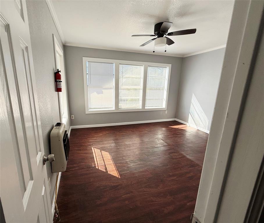 1633 Washington Avenue Fort Worth, TX 76104 - Photo 5 of 5 a view of empty room with wooden floor and fan