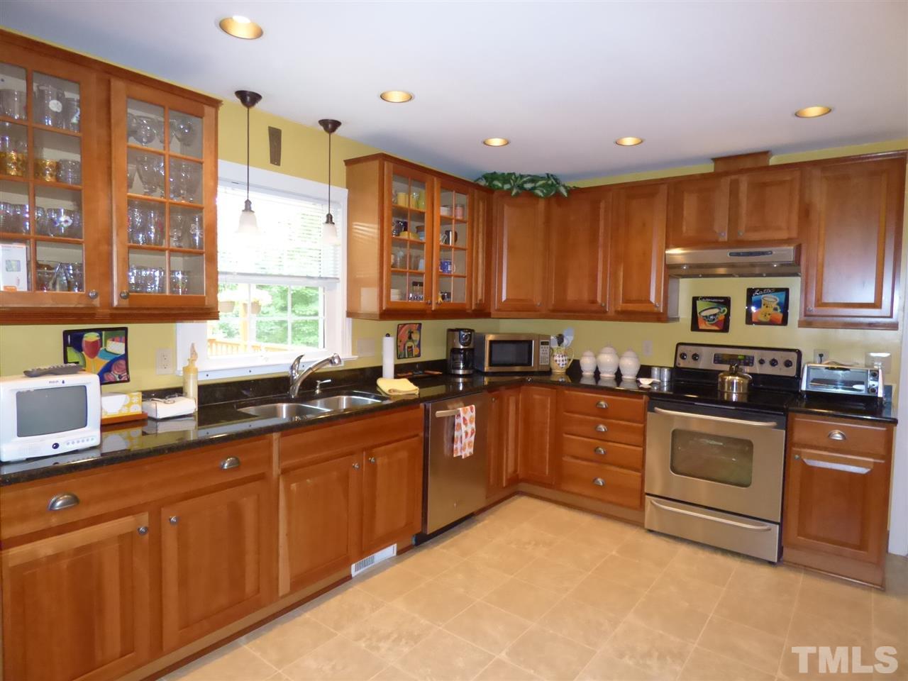 3117 Cartwright Drive Raleigh, NC 27612 - Photo 3 of 25 a kitchen with stainless steel appliances granite countertop a stove sink and cabinets