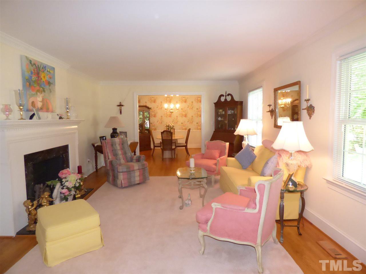 3117 Cartwright Drive Raleigh, NC 27612 - Photo 8 of 25 a living room with furniture and a fireplace
