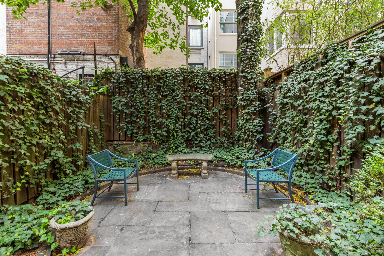 48 East 83rd Street, Unit GARDEN Manhattan, NY 10028 - Photo 16 of 16 a bench sitting in the middle of a yard