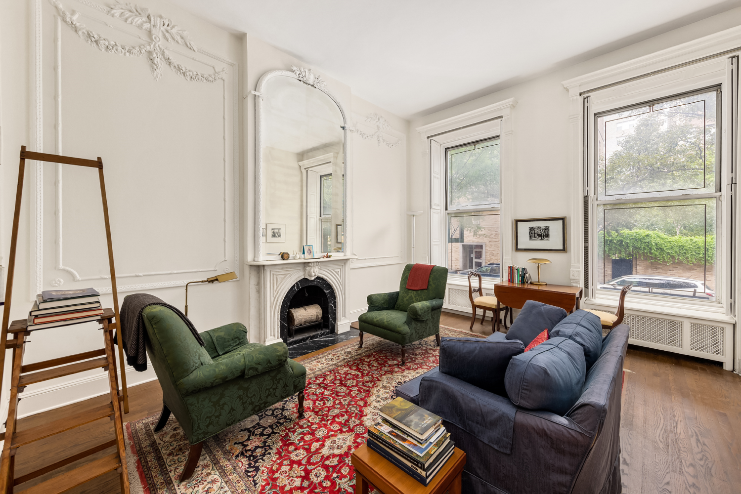 48 East 83rd Street, Unit GARDEN Manhattan, NY 10028 - Photo 4 of 16 a living room with furniture fireplace and a large window