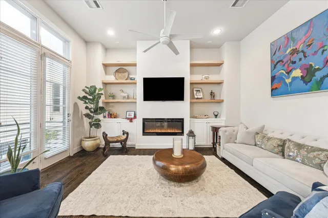 a living room with furniture a fireplace and a large window