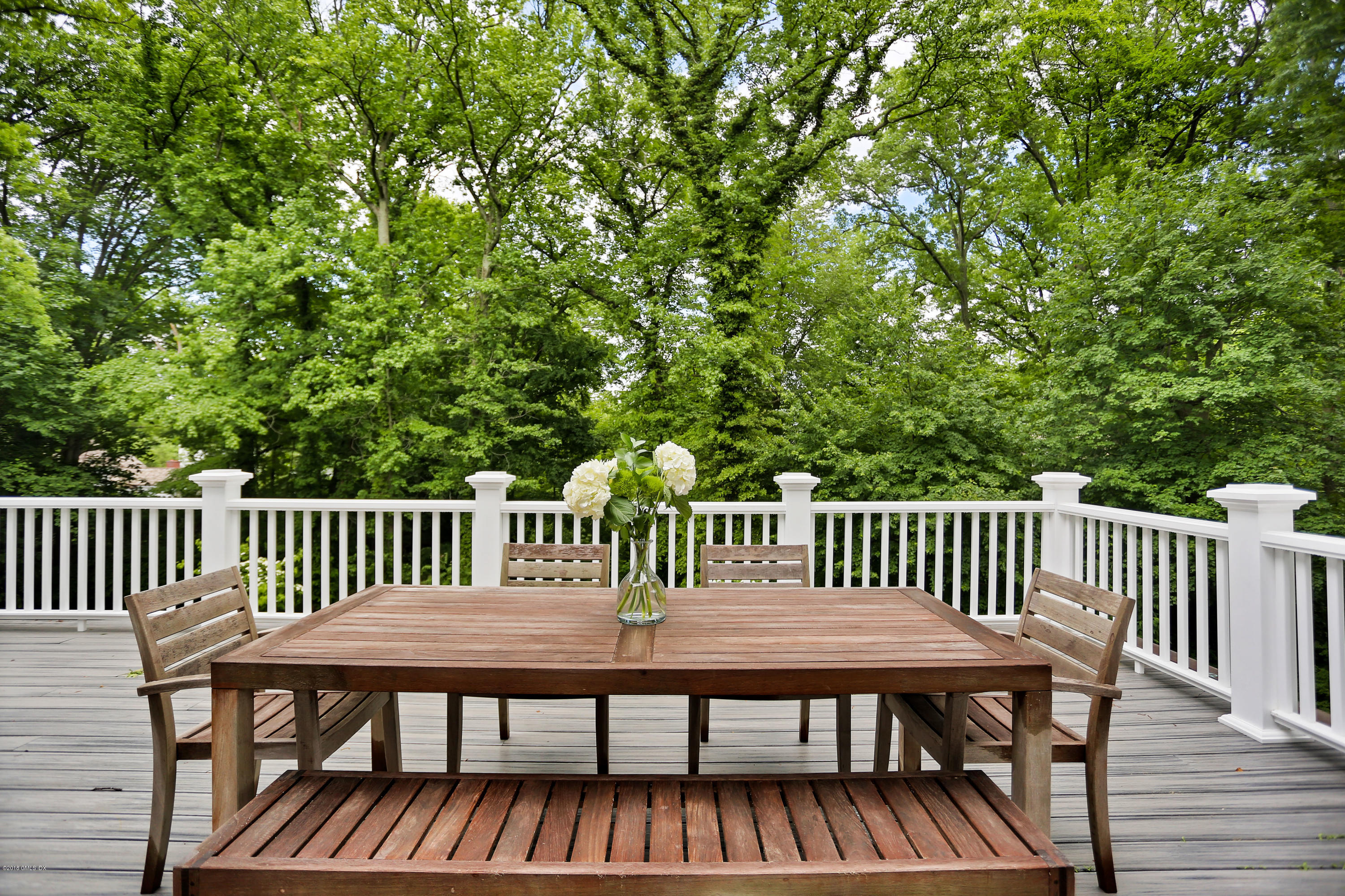 22 Oak Drive Riverside, CT 06878 - Photo 25 of 32 a view of a wooden deck with a bench
