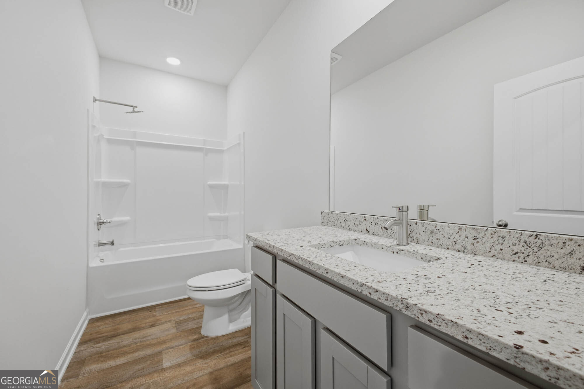 309 Rusty Plow Lane Perry, GA 31069 - Photo 18 of 34 a bathroom with a granite countertop sink a toilet and shower