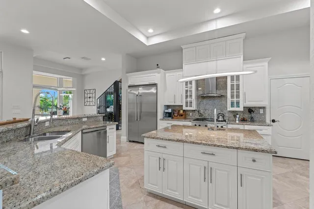 a bathroom with a granite countertop sink a toilet and a mirror