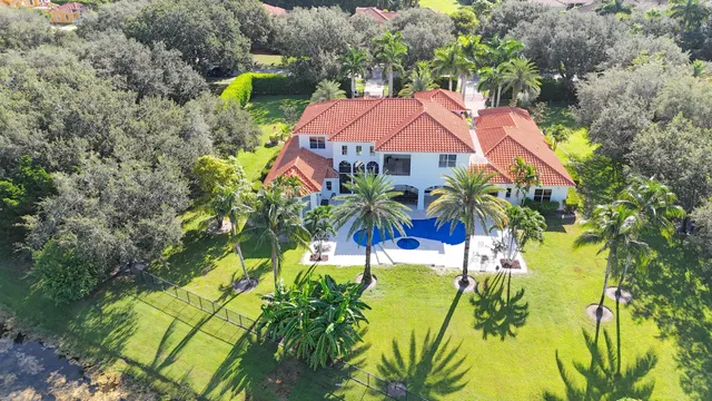 a large kitchen with stainless steel appliances granite countertop a lot of counter space and a sink