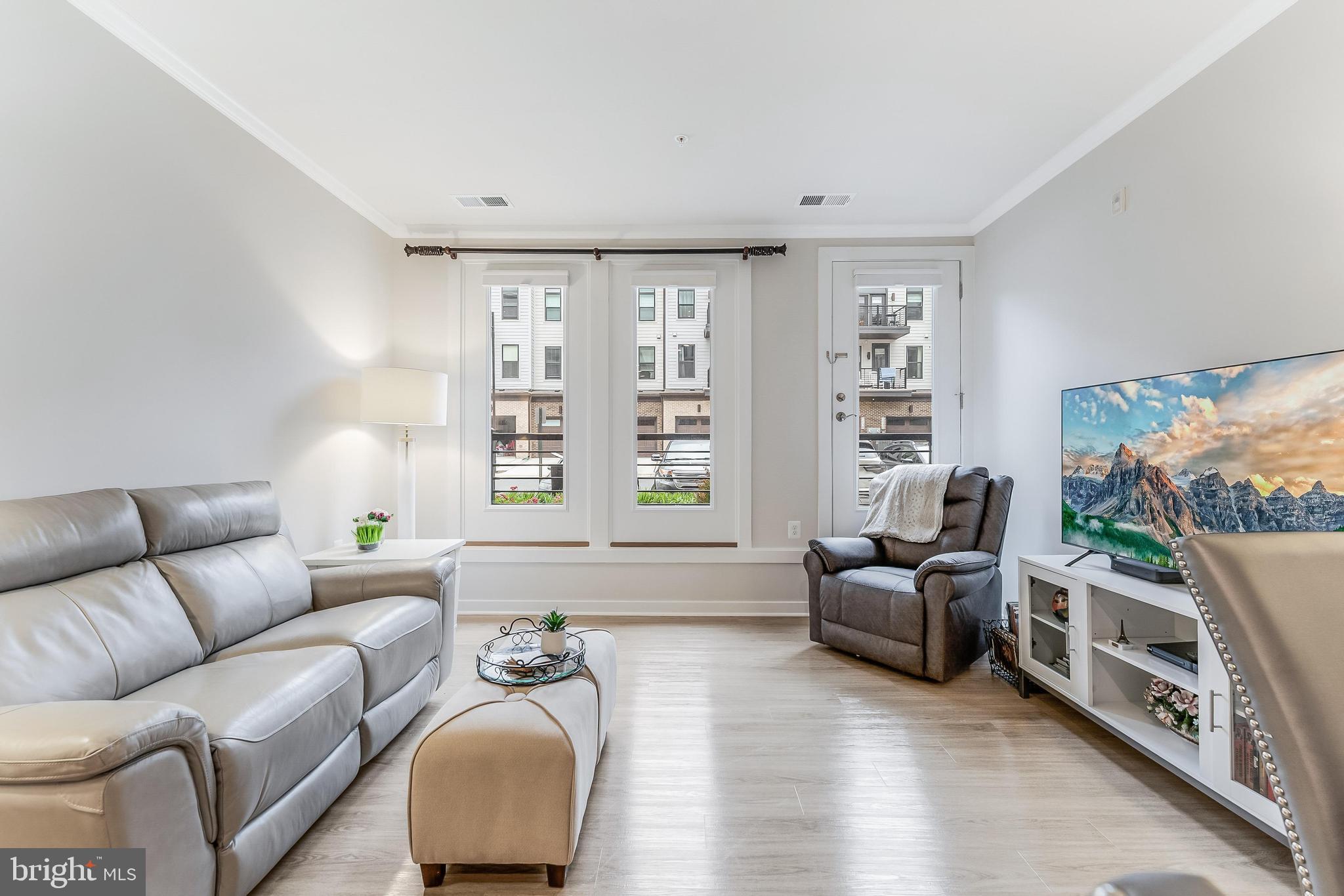 1675 Bandit Loop, Unit 105B Reston, VA 20190 - Photo 11 of 27 a living room with furniture and a flat screen tv