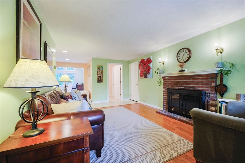 4 Rainbow Drive Medway, MA 02053 - Photo 14 of 42 a living room with furniture a fireplace and a flat screen tv