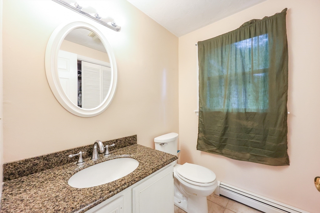 4 Rainbow Drive Medway, MA 02053 - Photo 15 of 42 a bathroom with a granite countertop sink toilet mirror and shower
